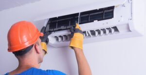 Struggling with AC Issues? How Professional Repair Services Can Help 6 Technician carefully examining an air conditioning unit for repair. Rup Air Condition provides fast and efficient AC repair services in Kolkata.